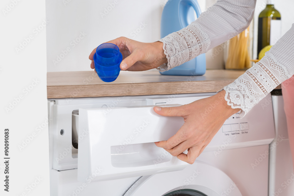 Female Hands Pouring Detergent In The Washing Machine Female Hands Pouring Detergent In The Washing Machine