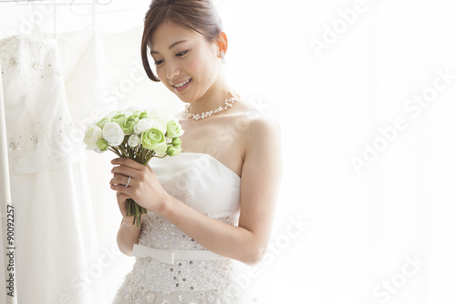 Bride is smiling with a wedding bouquet