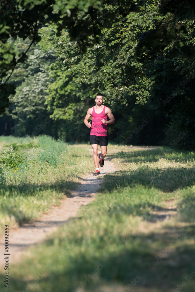 Young Handsome Man Running In The Park