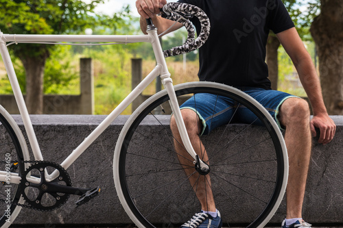 Hipster man with a fixie bike photo