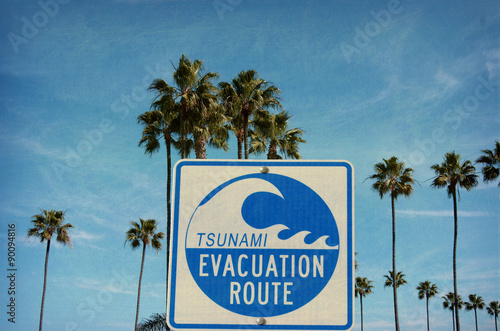 aged and worn vintage photo of tsunami warning sign