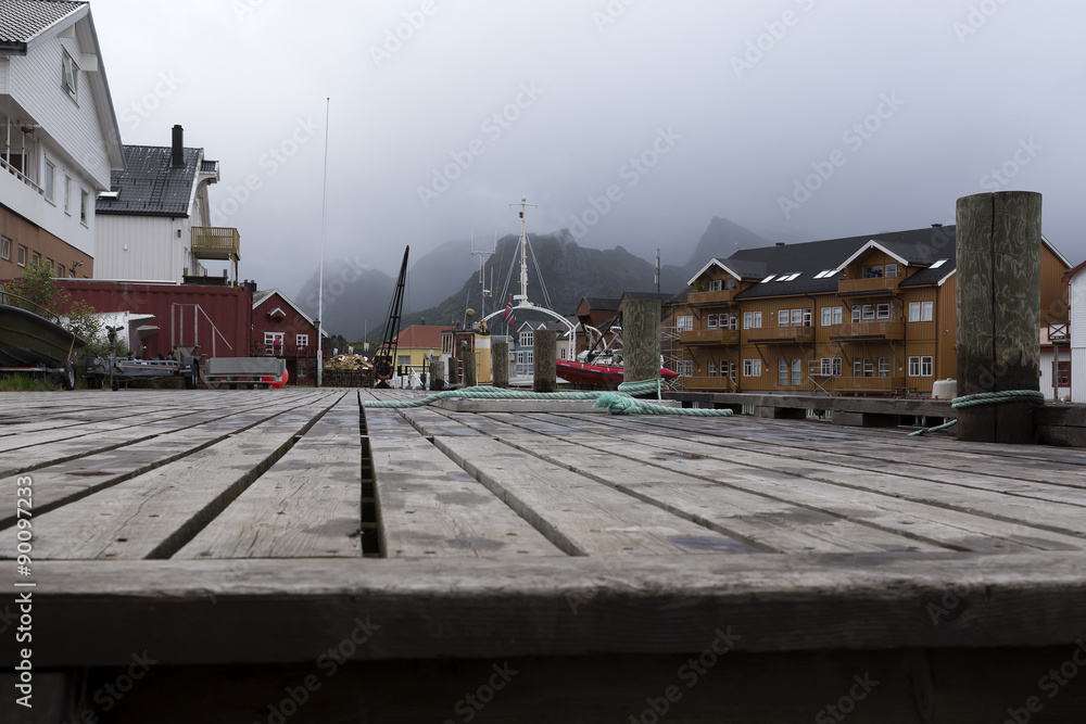 A pier from a low angle and some buildings on both sides 