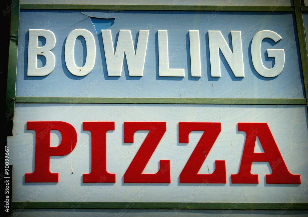 aged and worn vintage photo of bowling and pizza sign