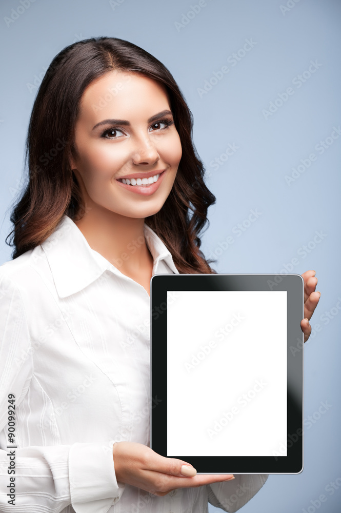 Businesswoman showing blank tablet pc, on grey Businesswoman showing blank tablet pc, on grey