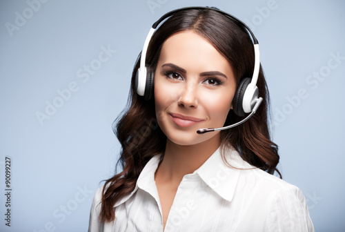 Portrait of cheerful customer support female phone operator in h