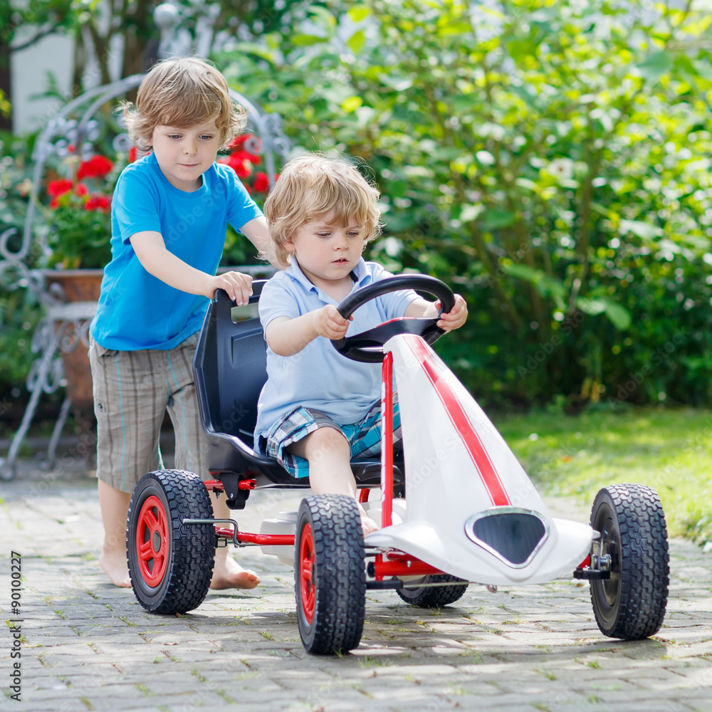 Two happy kid boys having fun with toy car Two happy kid boys having fun with toy car