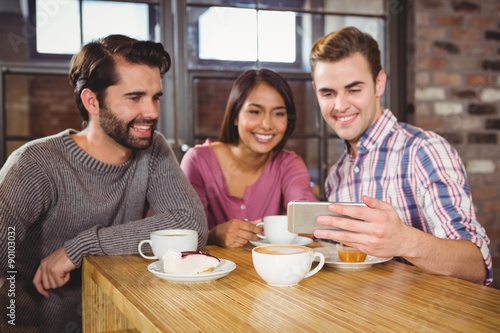 Group of friends looking at a smartphone