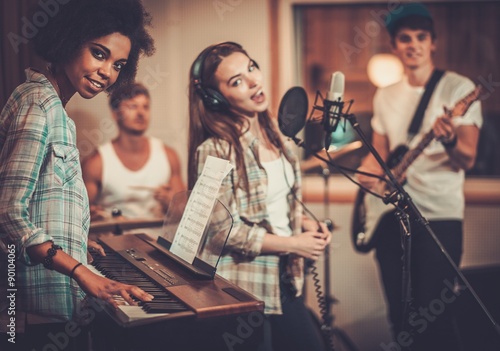 Fototapet Multiracial music band performing in a recording studio
