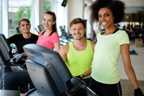 People on a elliptical training machine in a gym