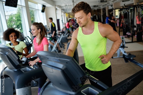 Man running on a treadmill in a gym