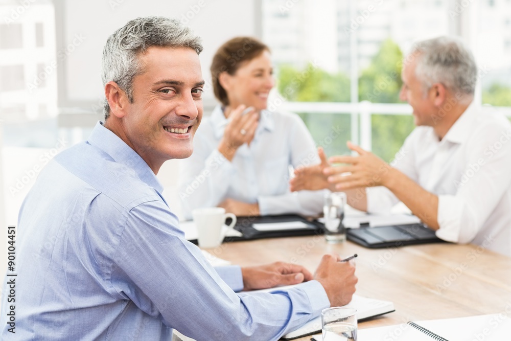 Smiling businessman in a meeting Smiling businessman in a meeting