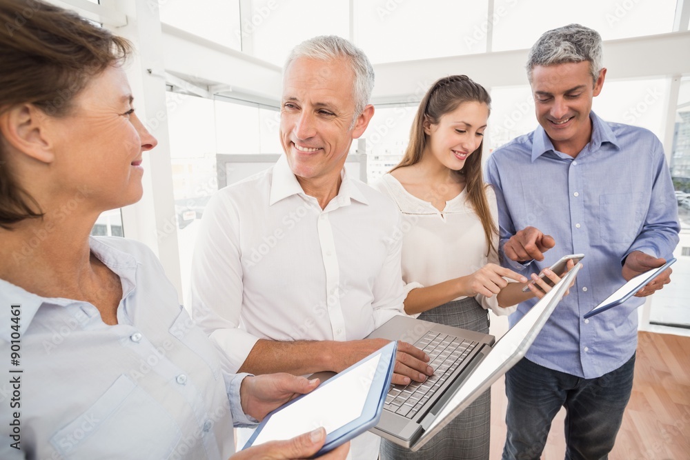 Business people using several electronic devices Business people using several electronic devices