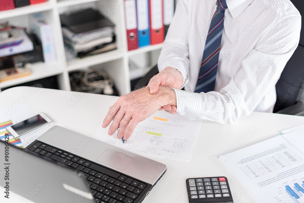 Businessman suffering from wrist pain Businessman suffering from wrist pain