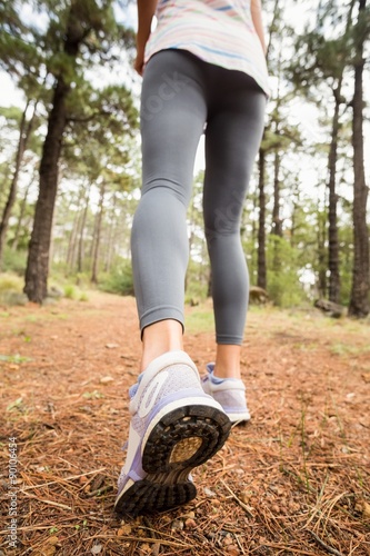 Young happy jogger walking