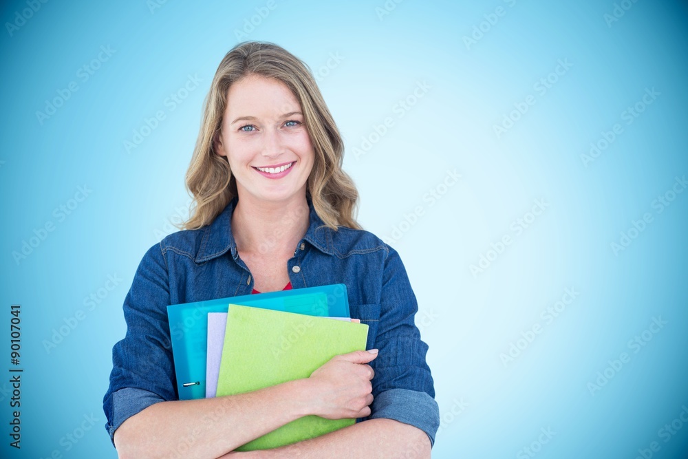 Composite image of smiling student holding notebook and file  - obrazy, fototapety, plakaty 