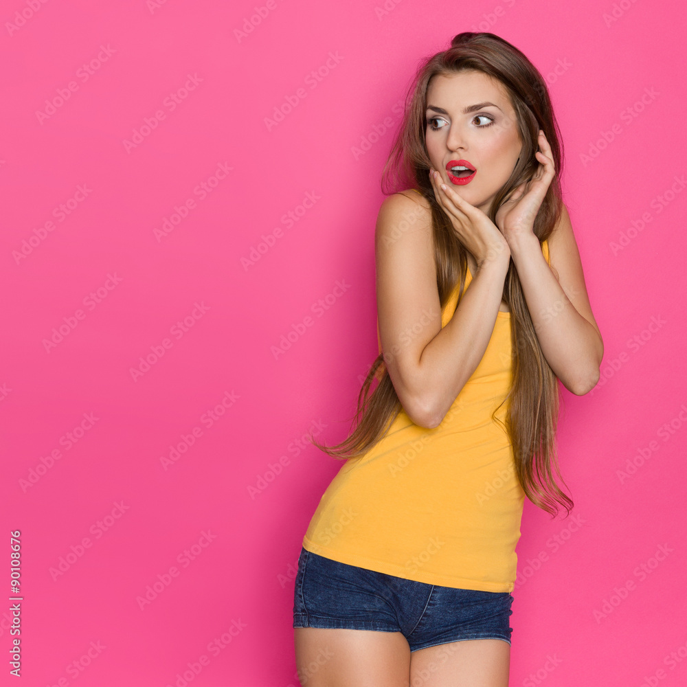 Shocked Woman Looking At Copy Space. Three quarter length studio shot on pink background. Shocked Woman Looking At Copy Space. Three quarter length studio shot on pink background.