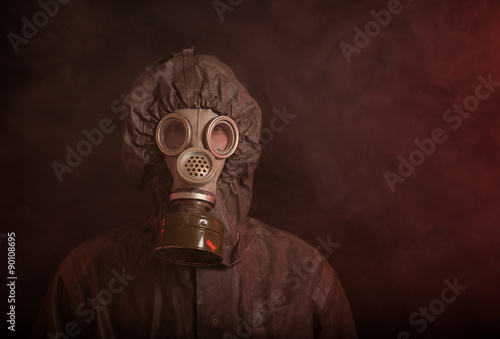Portrait of soldier in chemical protection armor and gas mask