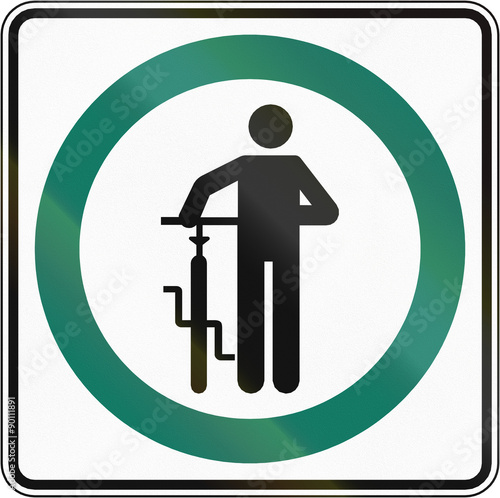 Regulatory road sign in Quebec, Canada - Cyclists dismount