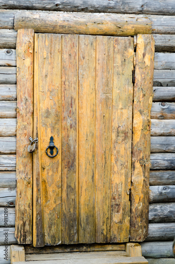 Loghouse wooden door with a padlock Loghouse wooden door with a padlock