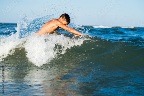 Teenager boy enjoying a swimming in the sea.