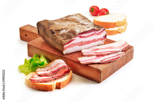 Cutting board with bacon and bread