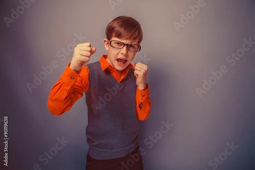 European-looking boy of ten years in glasses, anger, opened his 