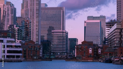 A hyperlapse motion view of London England Docklands shot from the Millwall Dock after sunset. Canary Wharf can be seen in the background.
 photo