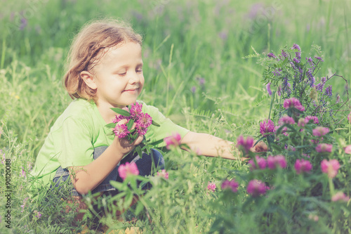 Cute little boy  playing with flowers in  park © altanaka