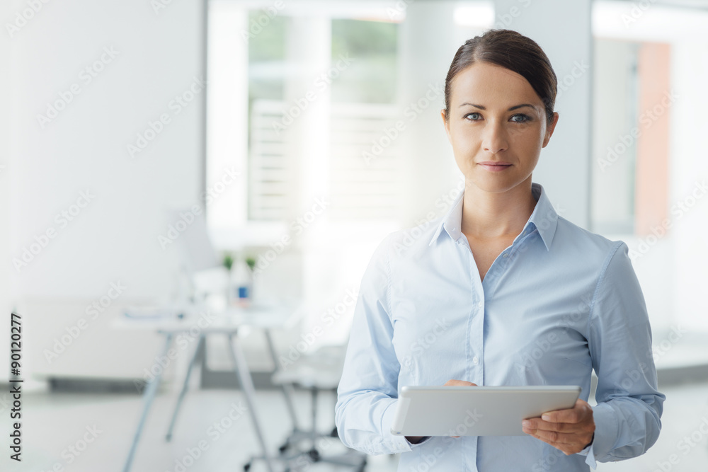 Business woman posing with a digital tablet Business woman posing with a digital tablet