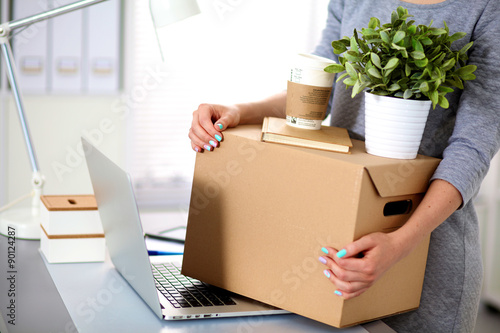 Happy team of businesspeople moving office, packing boxes