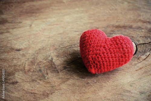 Red heart shape on old wooden background