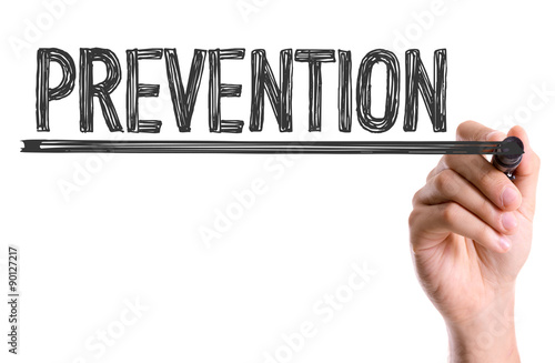 Hand with marker writing the word Prevention photo