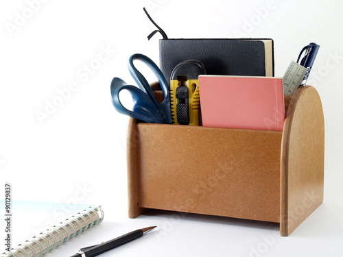 desk organizer with office supplies and stationery isolated on white photo