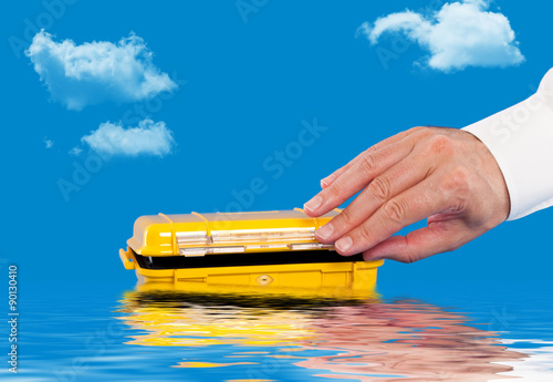 Opening a water resistant case floating in the water photo