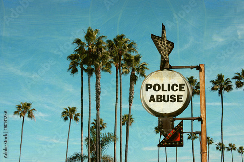 aged and worn vintage photo of police abuse sign