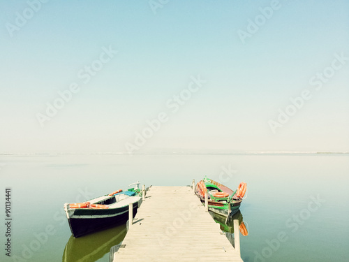 Calm lake with two fishing boats