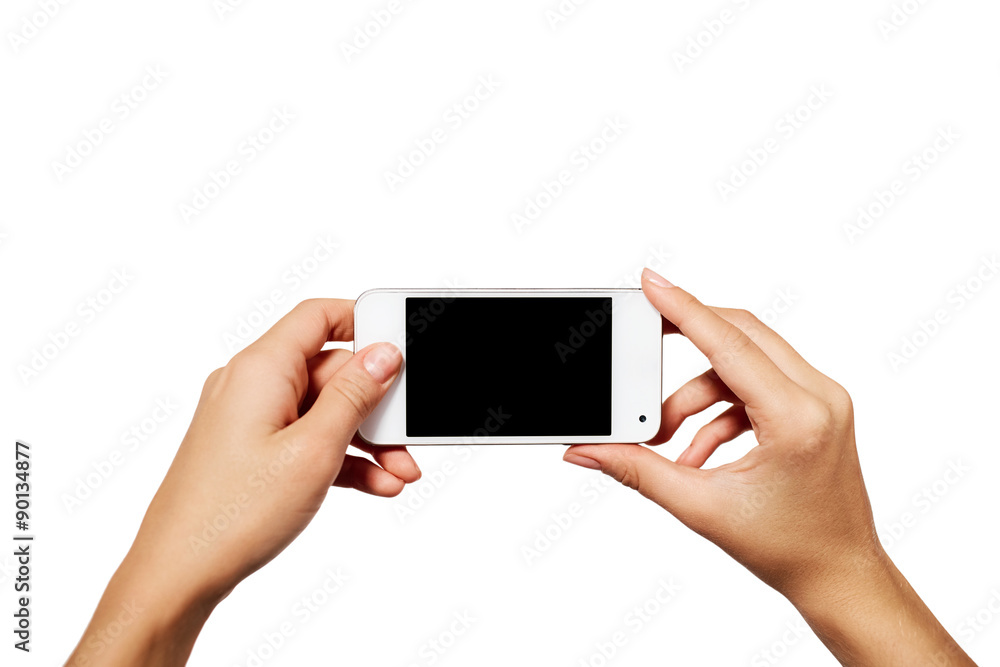 Hand holding smartphone with blank screen isolated on white back Hand holding smartphone with blank screen isolated on white back