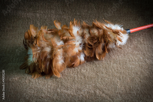 Soft feather broom on the brown carpet, Broom made of chicken fe © kriangphoto31