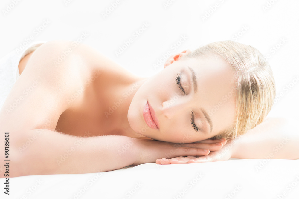 Beautiful young woman having leisure lying in a mat in spa. Beautiful young woman having leisure lying in a mat in spa.