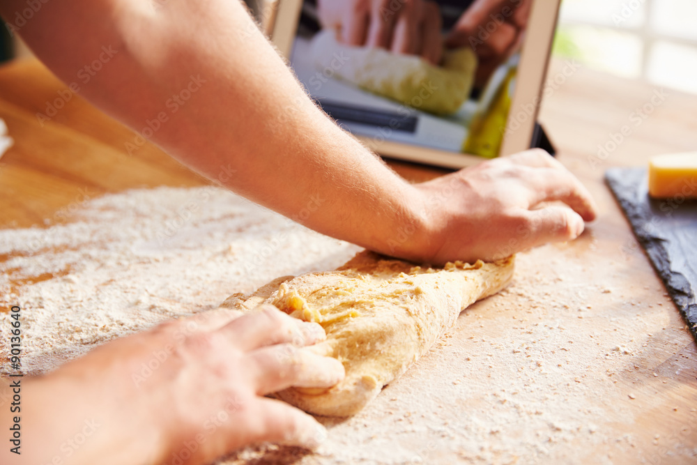 Person Following Pizza Recipe Using App On Digital Tablet Person Following Pizza Recipe Using App On Digital Tablet