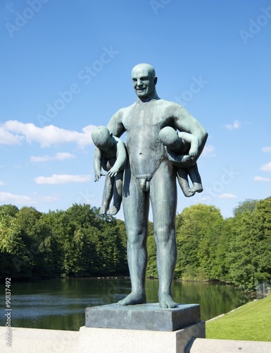 Man holding two babies at Vigeland Park in Oslo
