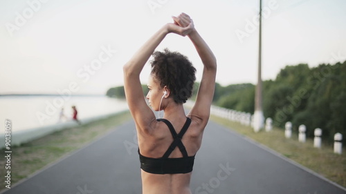 Wallpaper Mural Woman warms up before a run near lake Torontodigital.ca