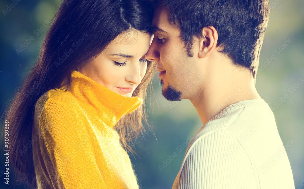 Young happy embracing couple walking together outdoors Young happy embracing couple walking together outdoors