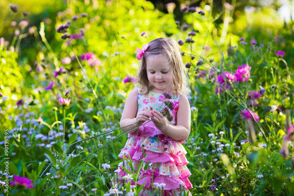 Little girl in flower garden Little girl in flower garden