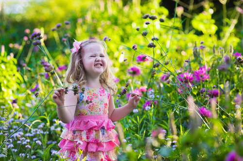 Little girl in flower garden