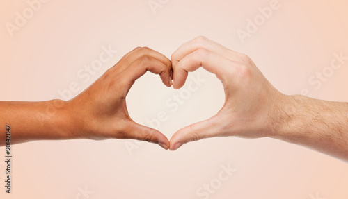 woman and man hands showing heart shape