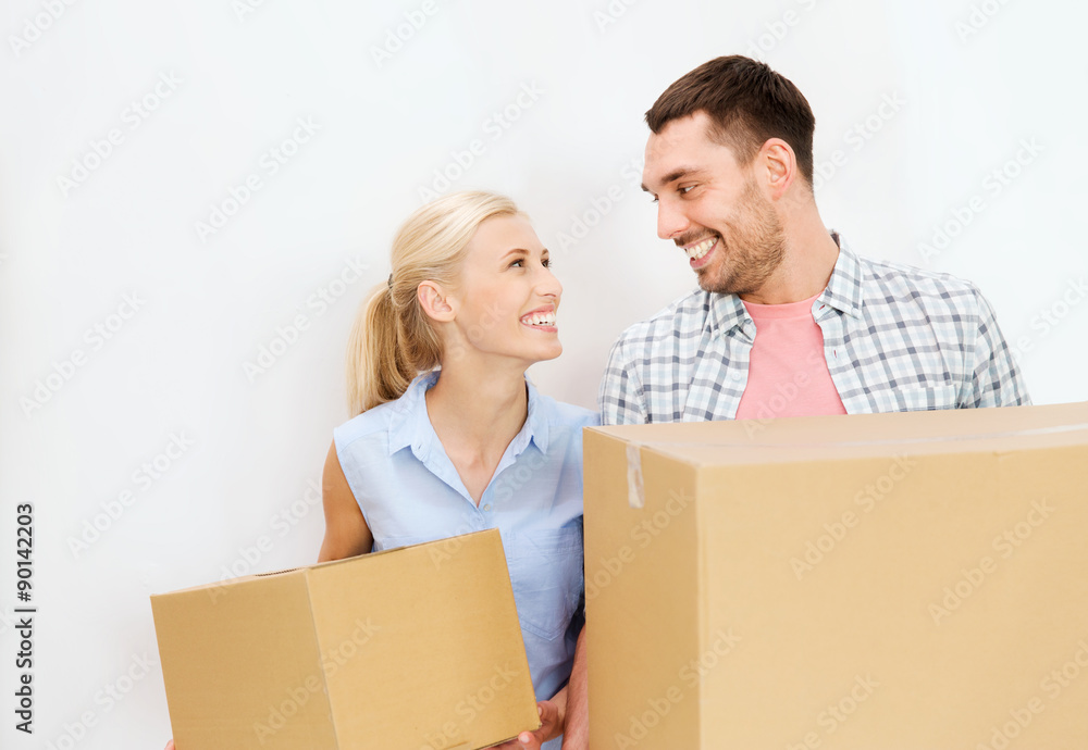 couple with cardboard boxes moving to new home couple with cardboard boxes moving to new home