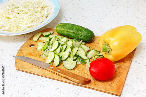 Fresh vegetable on wooden cutting board.