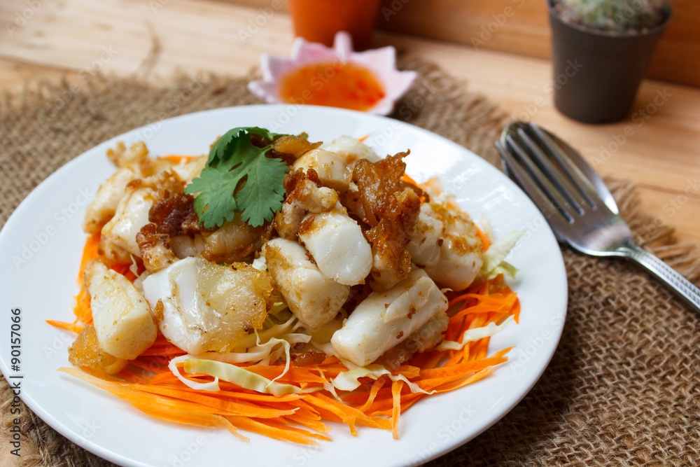 Fried squid serve with vegetable and sauce. Fried squid serve with vegetable and sauce.
