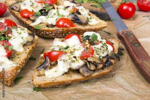delicious bruschetta with tomatoes, cheese and mushrooms